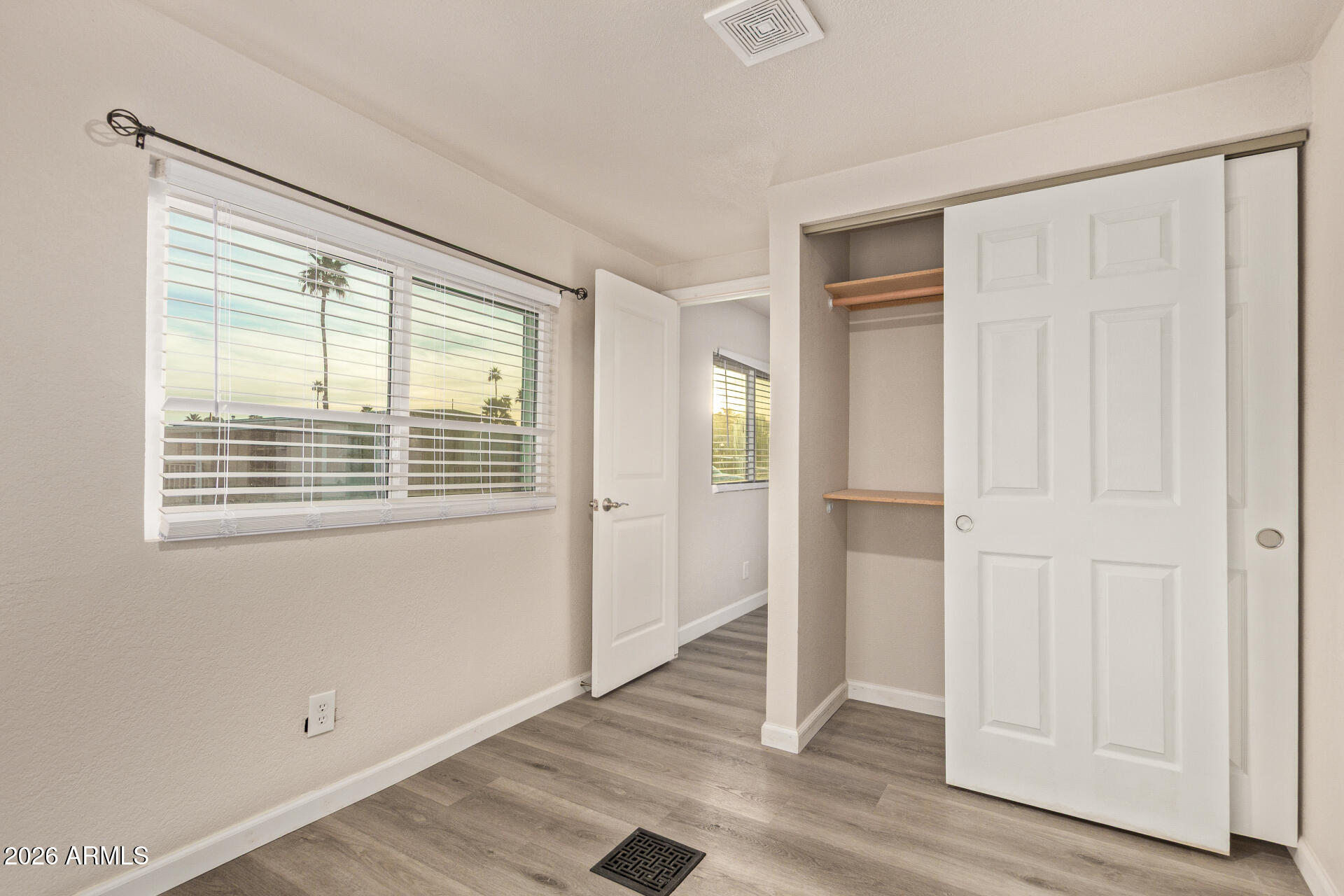 400 West Baseline Road, Unit 312 Tempe, AZ 85283 - Photo 24 of 32 a view of an empty room with wooden floor and a window