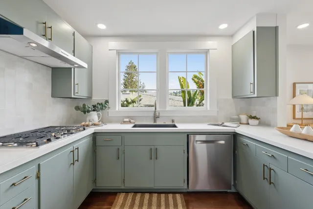 a kitchen with a sink cabinets and window