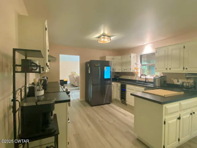 a view of a dining room with furniture and a chandelier