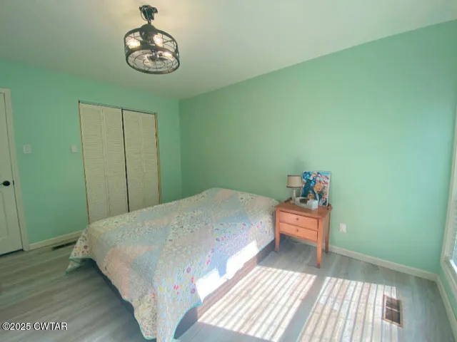 a aerial view of a house next to a big yard and large trees