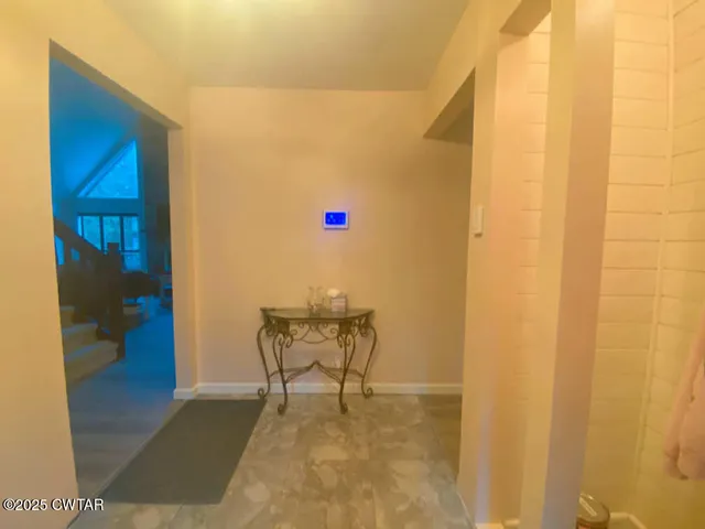 a view of an empty room with a chandelier