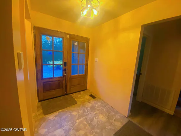a kitchen with stainless steel appliances granite countertop a refrigerator a sink dishwasher and a stove with wooden floor