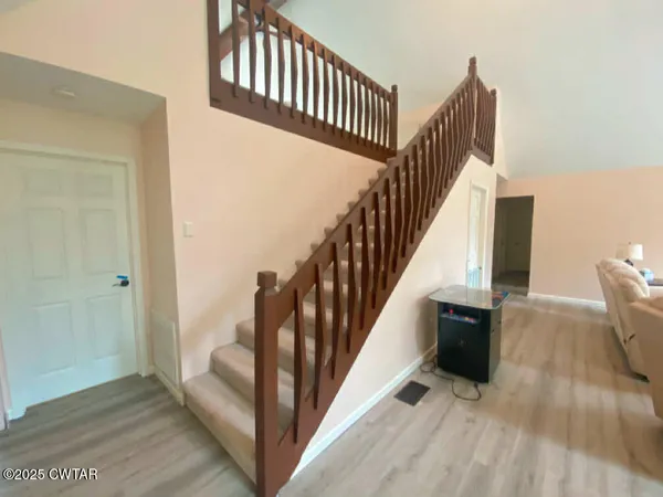 a bedroom with a bed and a night stand