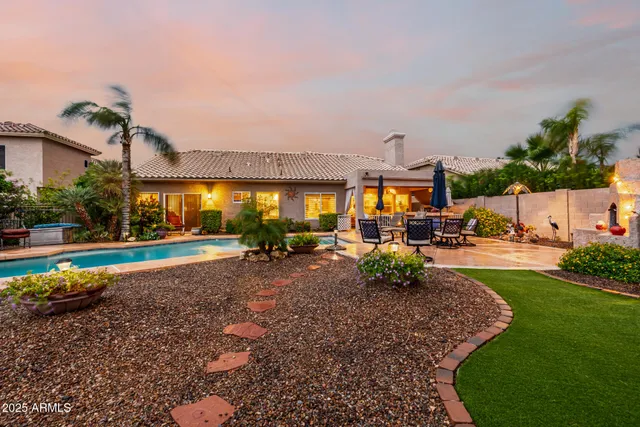 an aerial view of a house with a yard and fountain