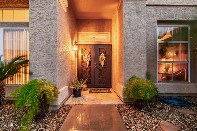 a view of a swimming pool with a yard and palm trees