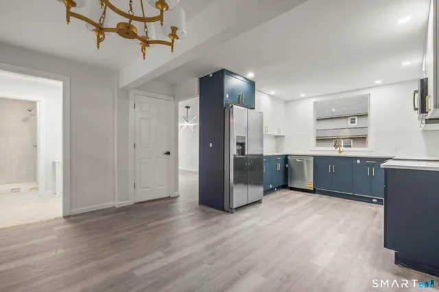 a kitchen with stainless steel appliances a refrigerator and a sink