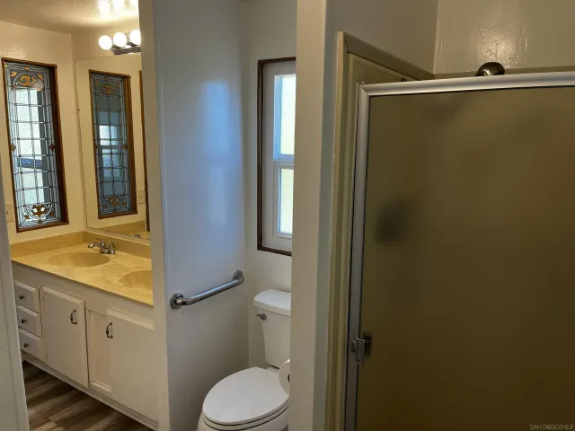 a bathroom with a shower and a door
