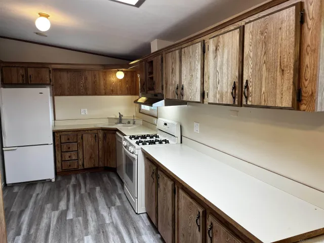 a kitchen with granite countertop cabinets stainless steel appliances and sink