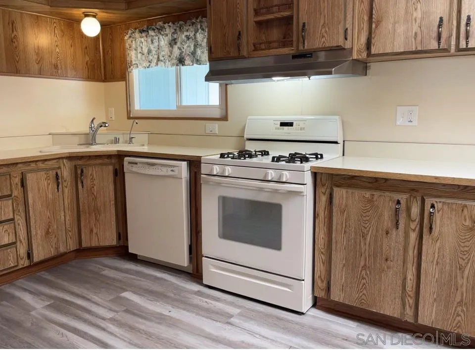 909 Richland Road, Unit 134 San Marcos, CA 92069 - Photo 20 of 44 a kitchen with granite countertop cabinets stainless steel appliances and sink