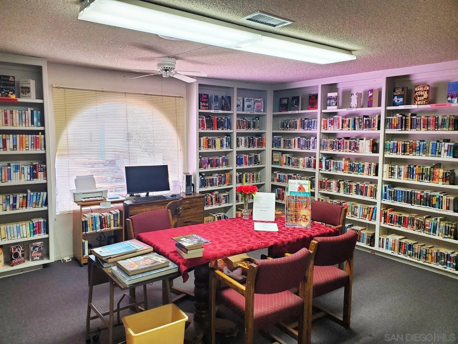 909 Richland Road, Unit 134 San Marcos, CA 92069 - Photo 42 of 44 a view of a workspace with furniture and a bookshelf