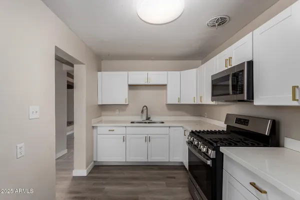 a kitchen with a sink stove and microwave