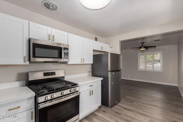 a kitchen with a stove a microwave and refrigerator