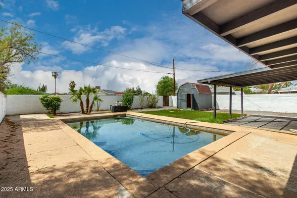 a view of swimming pool with outdoor seating
