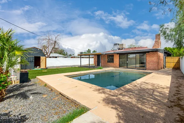 a view of pool with a yard