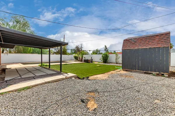 a backyard of a house with yard and outdoor seating