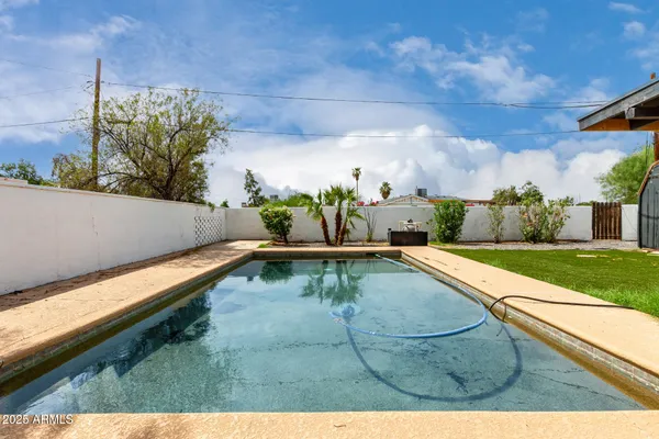 a view of a swimming pool with a yard