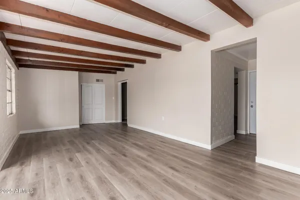 a view of a hallway with wooden floor and a hallway