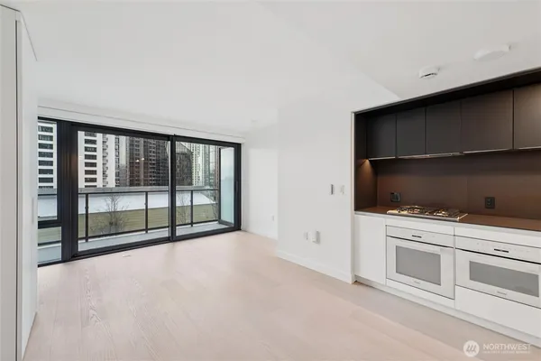 a view of a kitchen with dishwasher and white cabinets