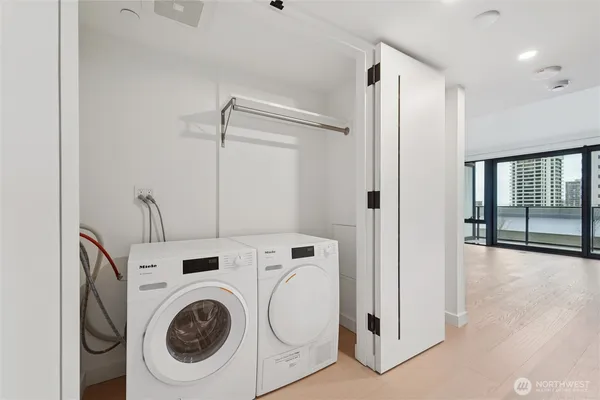 a living room with flat screen tv and refrigerator