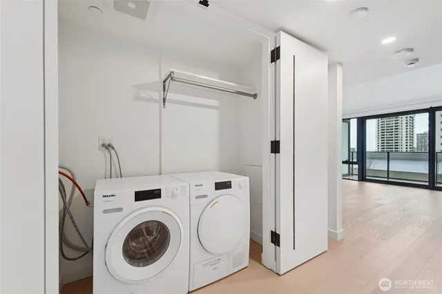 a living room with flat screen tv and refrigerator