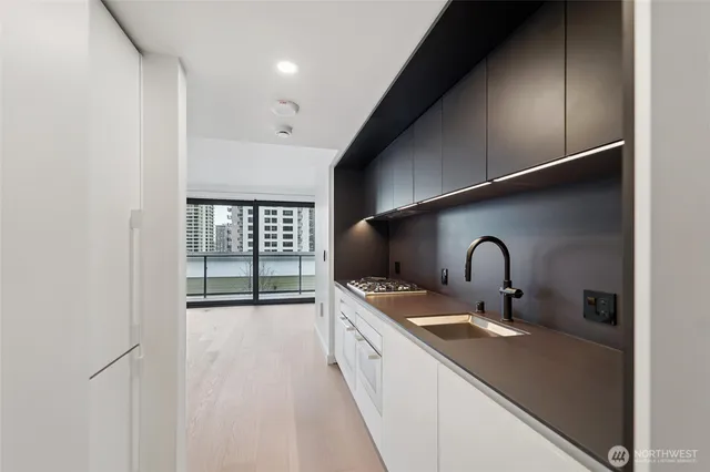 a kitchen with a sink a stove and cabinets