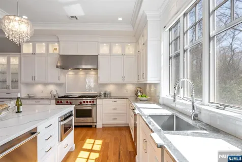 a kitchen with a stove a sink and a granite counter tops