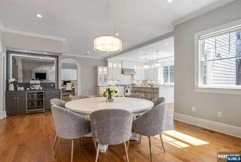 a large white kitchen with a dining table and chairs