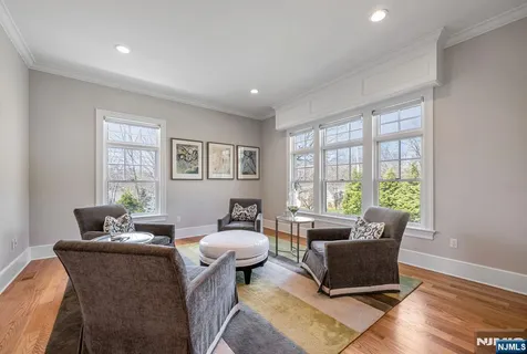 a living room with furniture and large windows