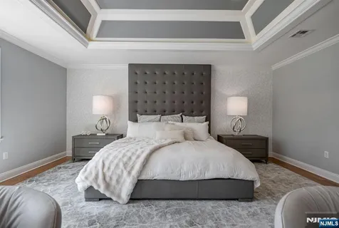 a bedroom with a bed lamp and a fireplace
