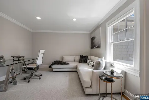 a living room with furniture gym equipment and a window