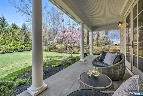 a living room with patio furniture and a potted plant