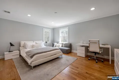 a spacious bedroom with a bed and a chair