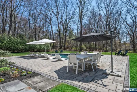 a patio with a patio table and chairs