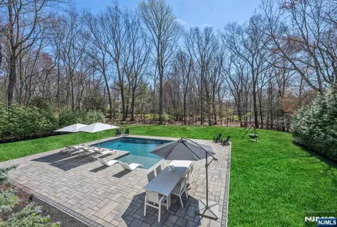 a view of backyard with seating area and green space