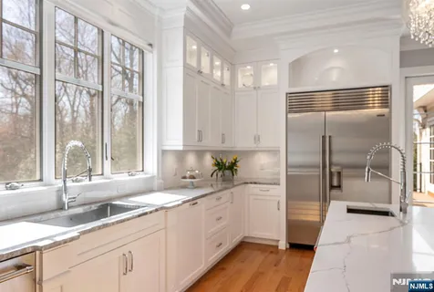 a large kitchen with a large window and refrigerator