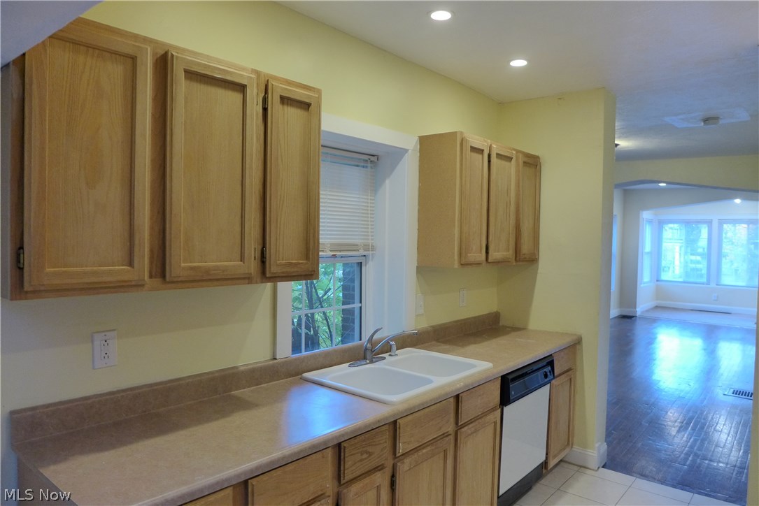 Updated cabinets offering loads of storage space along with new counter tops and ceramic floors make this a fun cooking work space.
