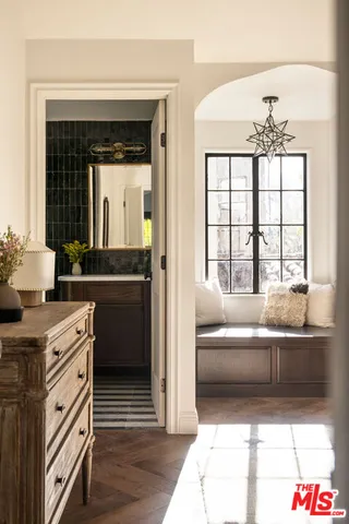 a en suite bathroom with a granite countertop tub and a double vanity sink