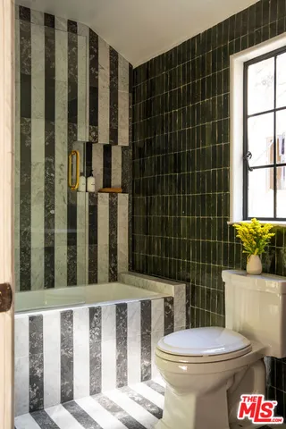 a bathroom with a toilet and shower