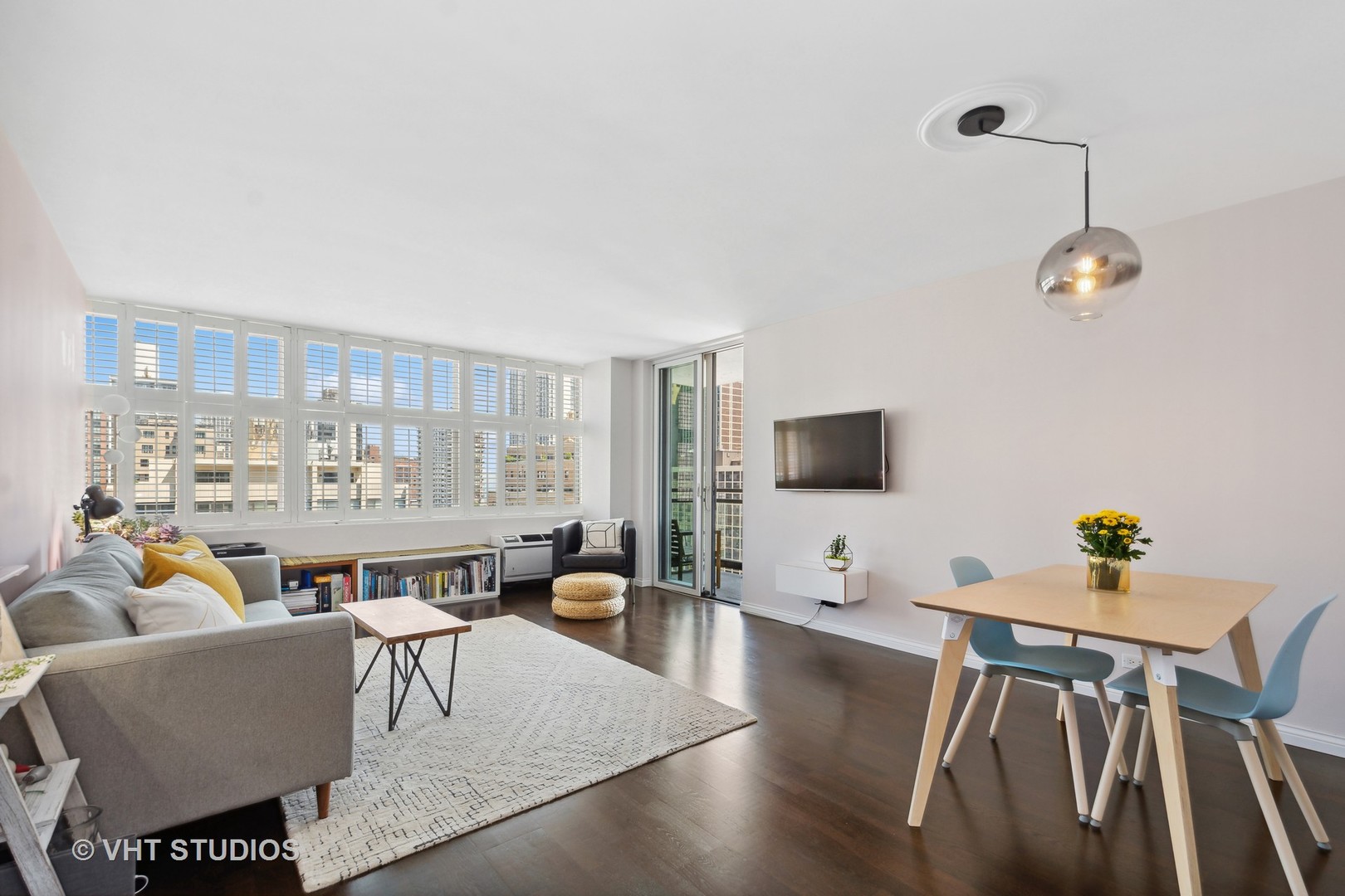 30 East Elm Street, Unit 18A Chicago, IL 60611 - Photo 2 of 16 a living room with furniture and a flat screen tv
