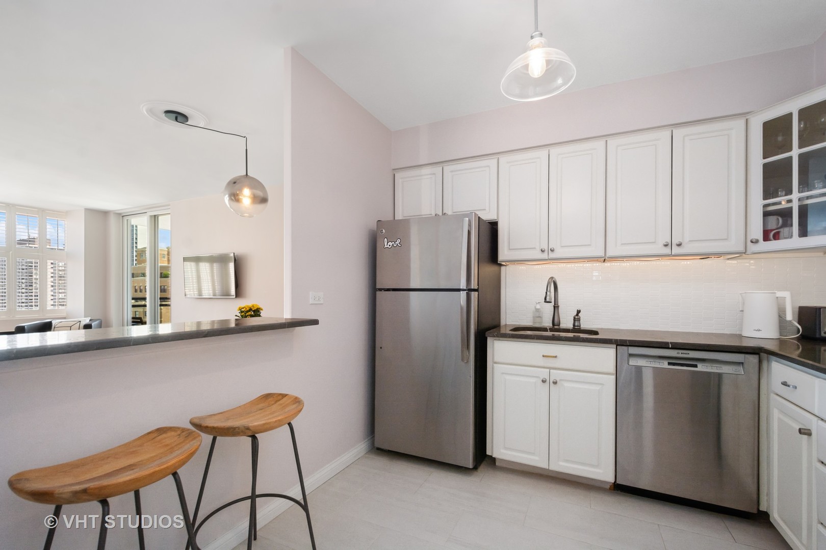 30 East Elm Street, Unit 18A Chicago, IL 60611 - Photo 5 of 16 a kitchen with stainless steel appliances granite countertop a sink a stove a refrigerator and cabinets