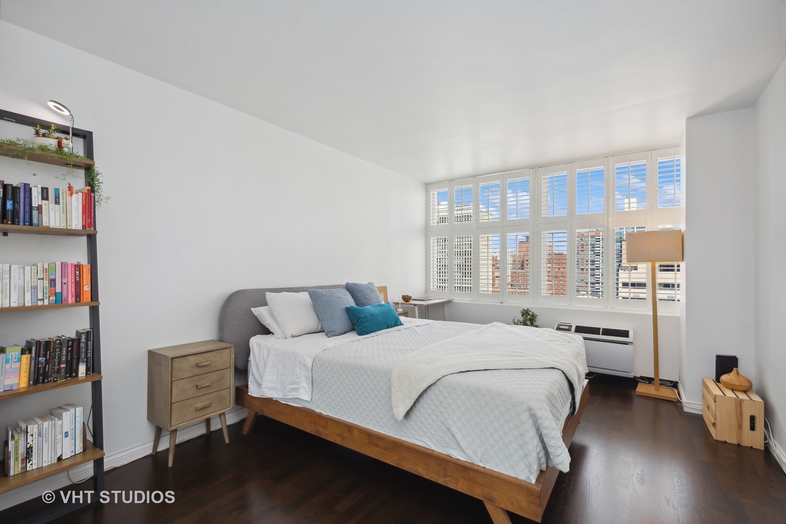 30 East Elm Street, Unit 18A Chicago, IL 60611 - Photo 7 of 16 a bedroom with a bed and a book shelf