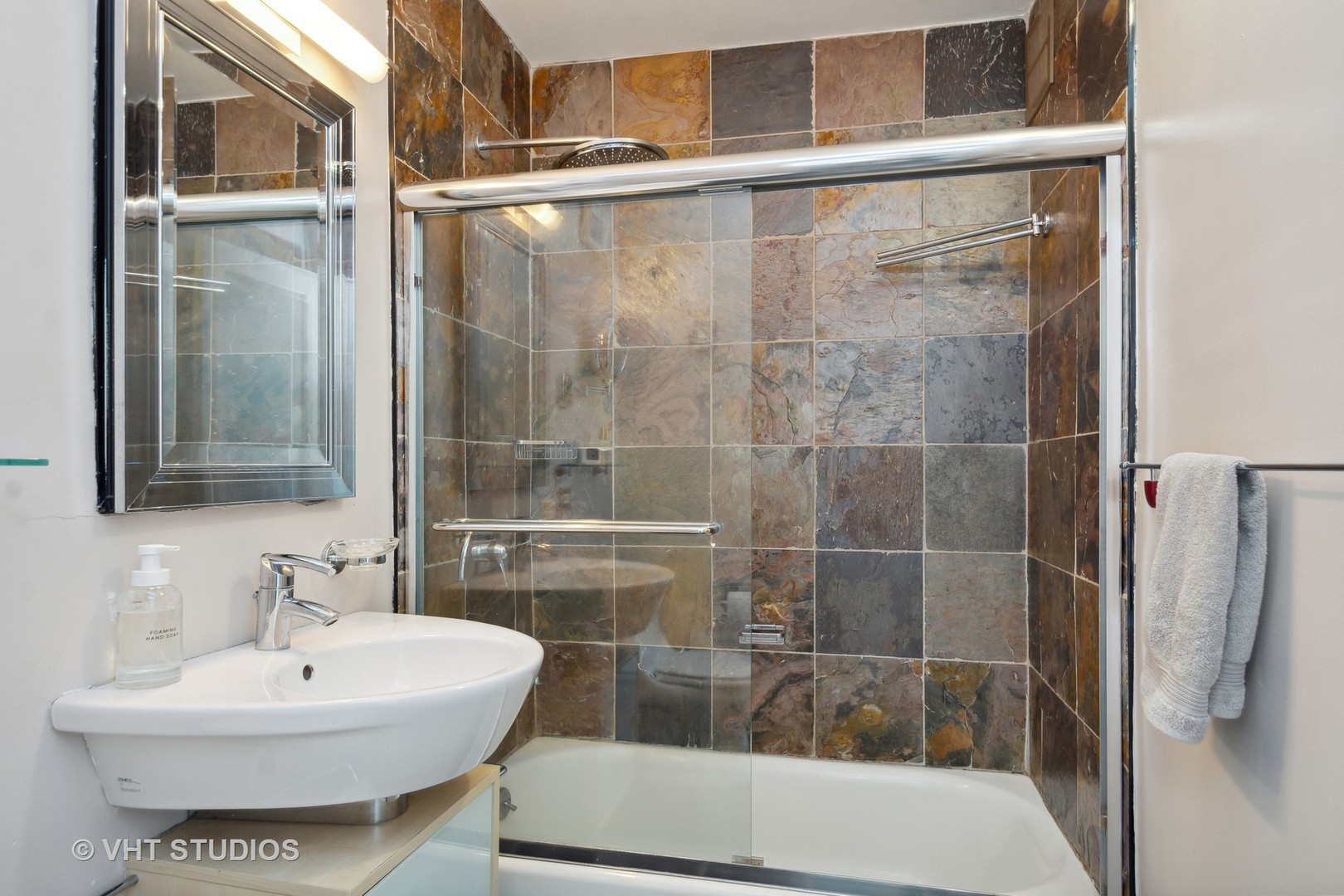 30 East Elm Street, Unit 18A Chicago, IL 60611 - Photo 9 of 16 a bathroom with a sink toilet and shower