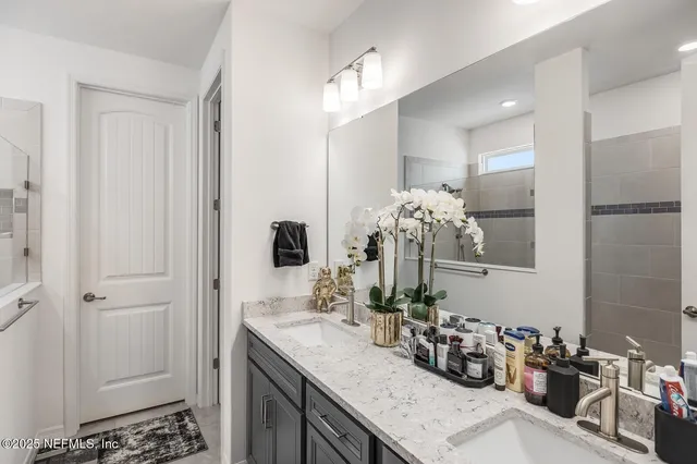a bathroom with a sink double vanity and a mirror