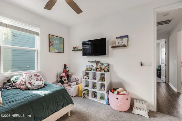 a bedroom with furniture and a flat screen tv