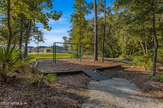 a view of a backyard with swimming pool