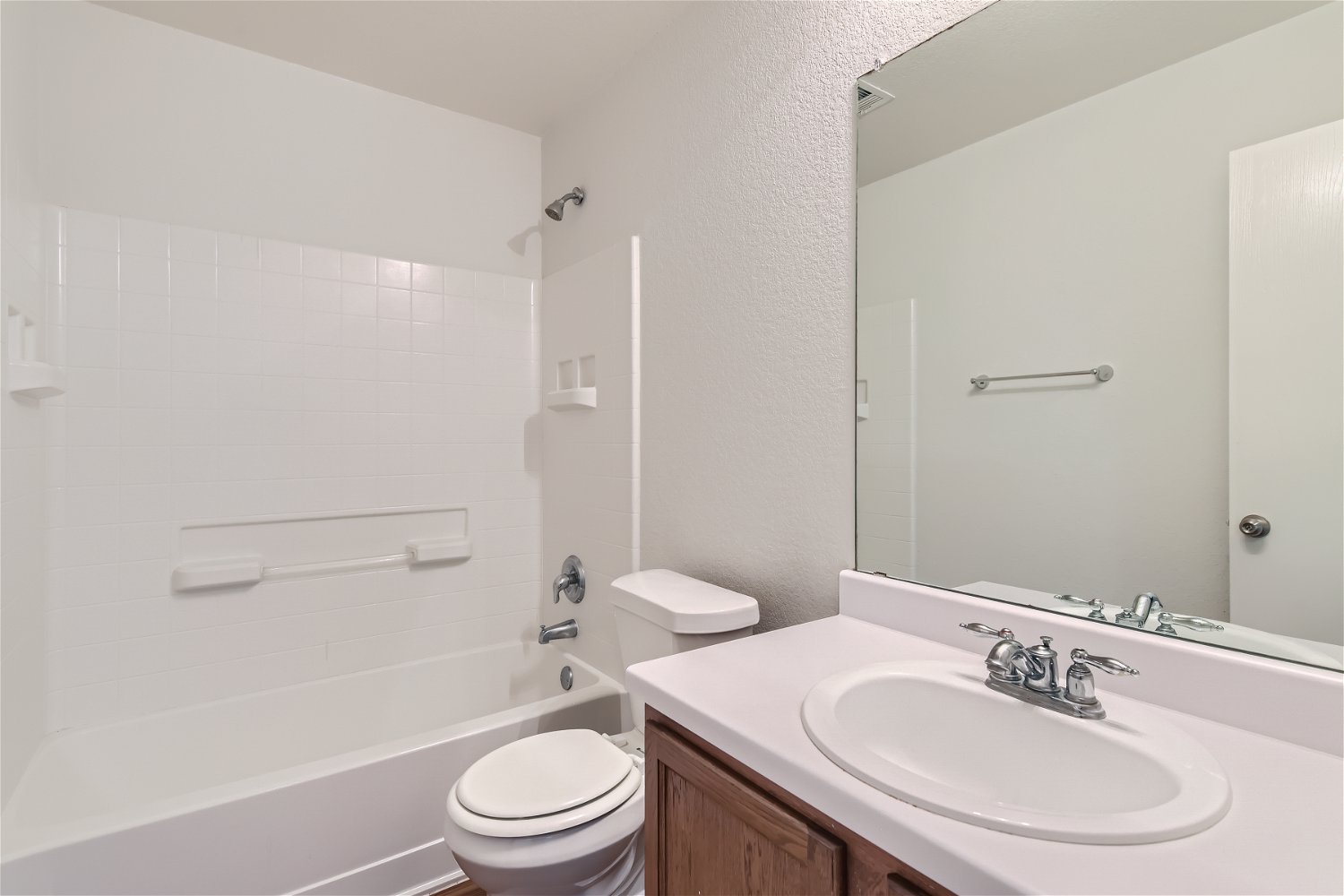 18408 Cloudmore Lane Elgin, TX 78621 - Photo 5 of 11 A well-maintained bathroom with a sleek vanity and convenient shower-tub combination.