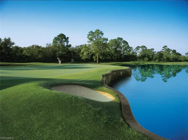 a view of a dining room with furniture a chandelier and large windows