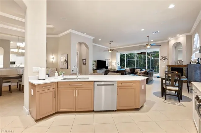 a kitchen with a sink and chairs