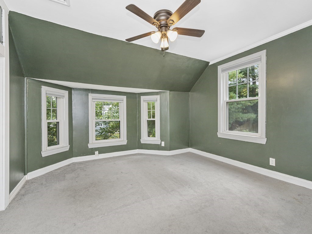 89 Green Street Wakefield, MA 01880 - Photo 13 of 38 a view of a big room with windows and chandelier fan