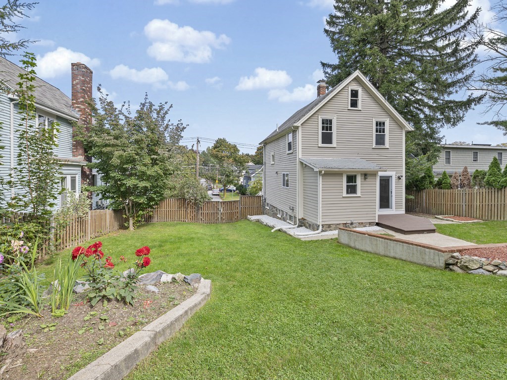 89 Green Street Wakefield, MA 01880 - Photo 28 of 38 a front view of a house with a yard and garage